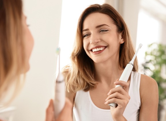 Smiling woman holding toothbrush