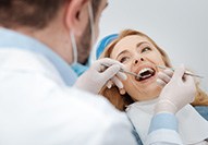 dentist looking at patient’s mouth