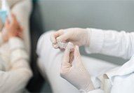 a dentist holding a pair of aligners