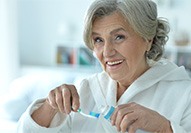 Dentures patient in Carmel performing oral hygiene