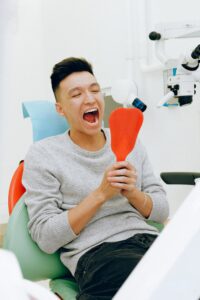 Happy man in dentist’s chair